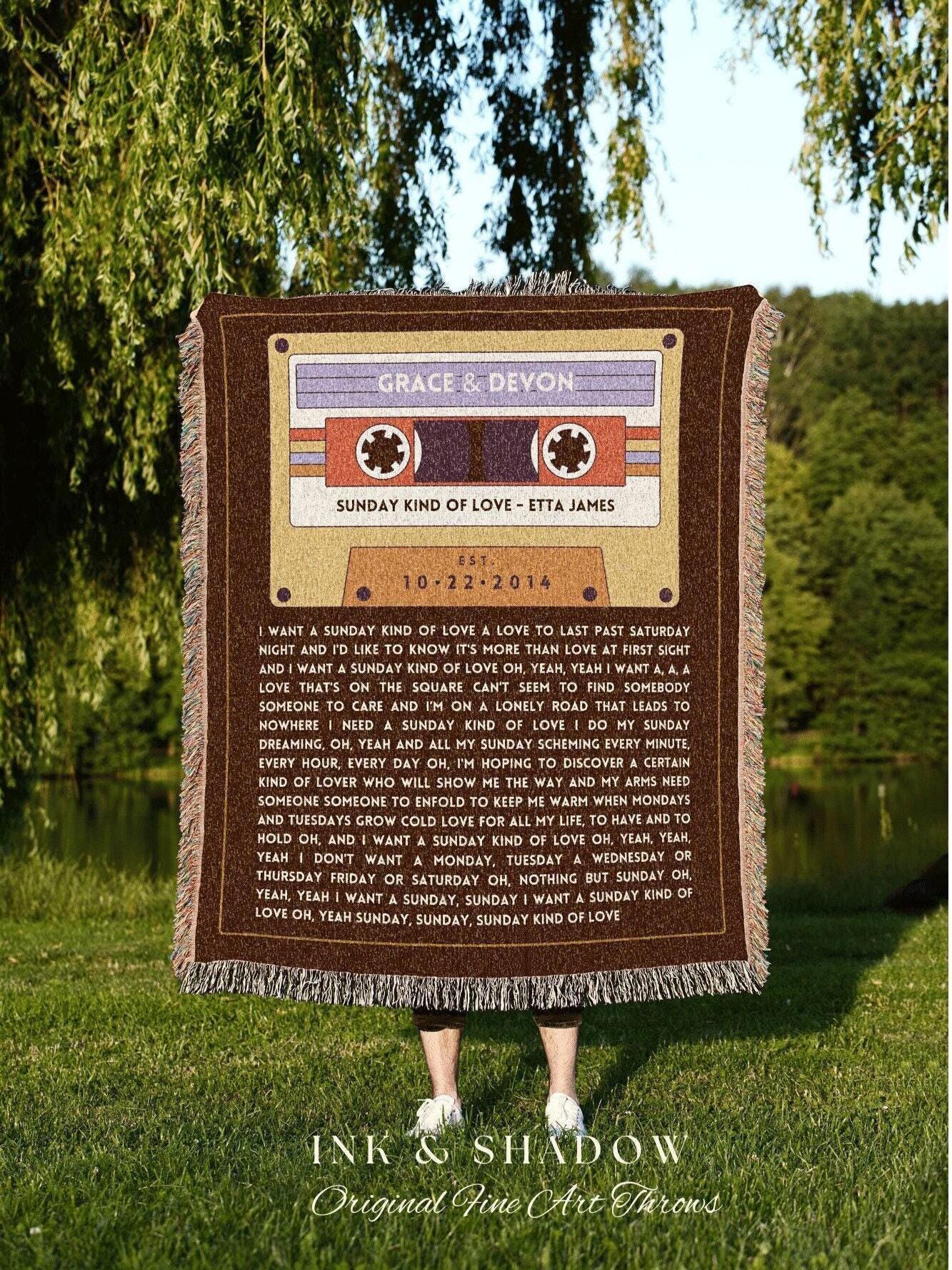 May include: A brown throw blanket with a cassette tape design, featuring the names "Grace & Devon" and the date "10-22-2014." The text "Sunday Kind of Love - Etta James" is also visible. The blanket has a fringed edge and the words "Ink & Shadow Original Fine Art Throws."