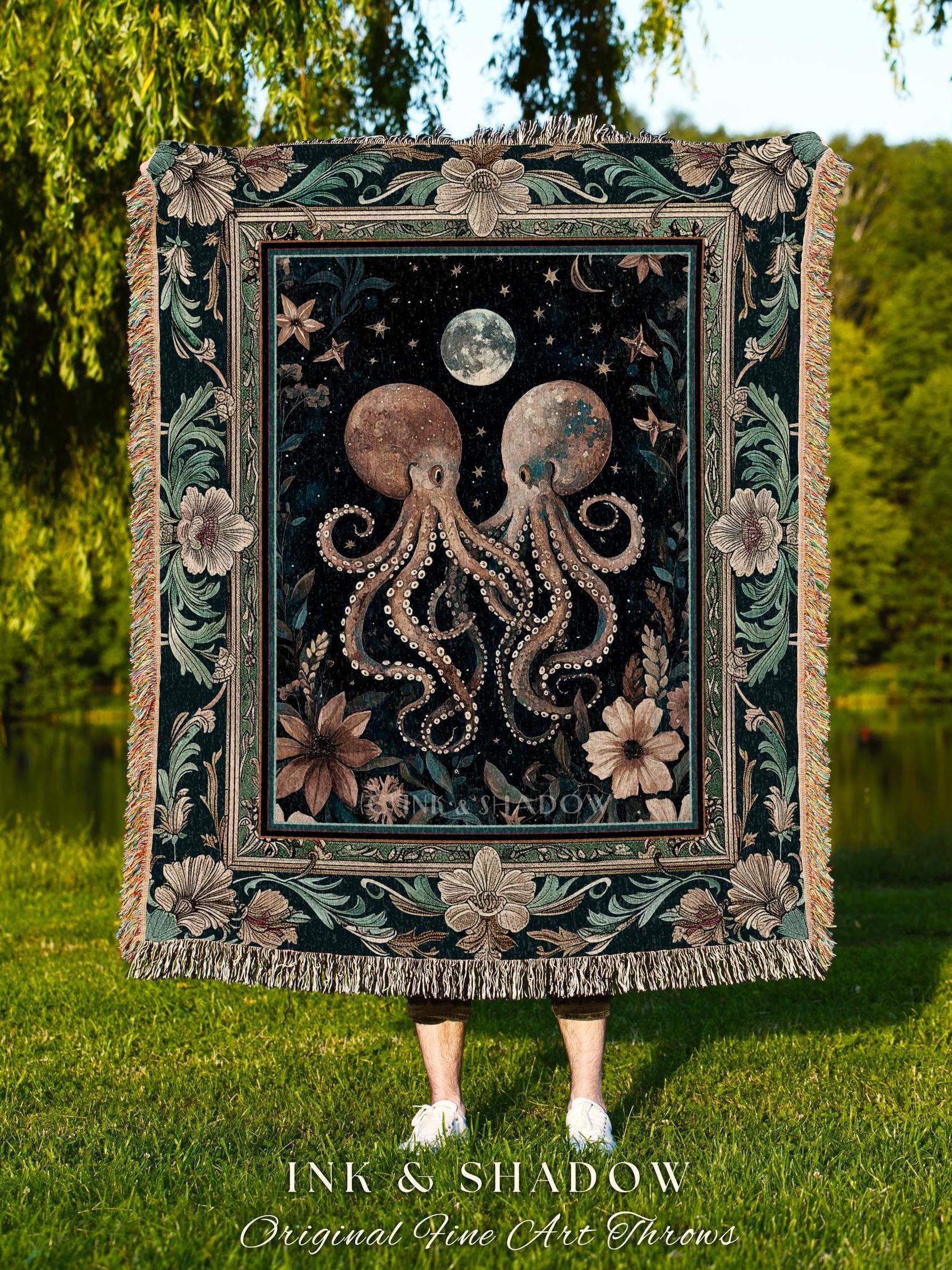 May include: A decorative throw blanket featuring a dark background with two octopuses, a moon, and stars. The blanket has a floral border and fringe. The text "INK & SHADOW Original Fine Art Throws" is at the bottom.