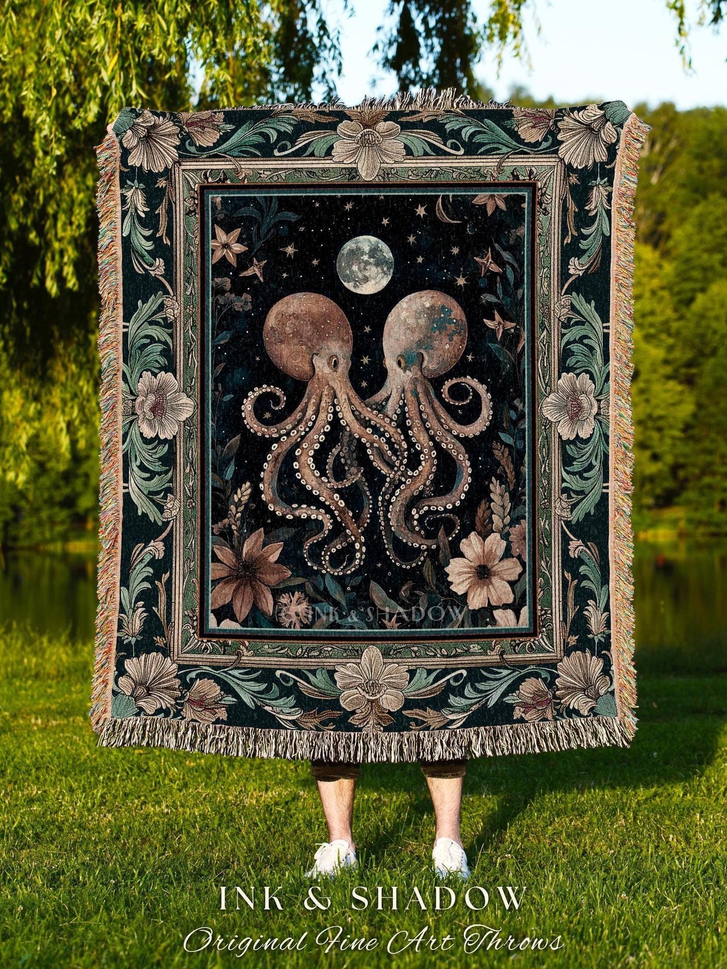 May include: A decorative throw blanket featuring a dark background with two octopuses, a moon, and stars. The blanket has a floral border and fringe. The text "INK & SHADOW Original Fine Art Throws" is at the bottom.