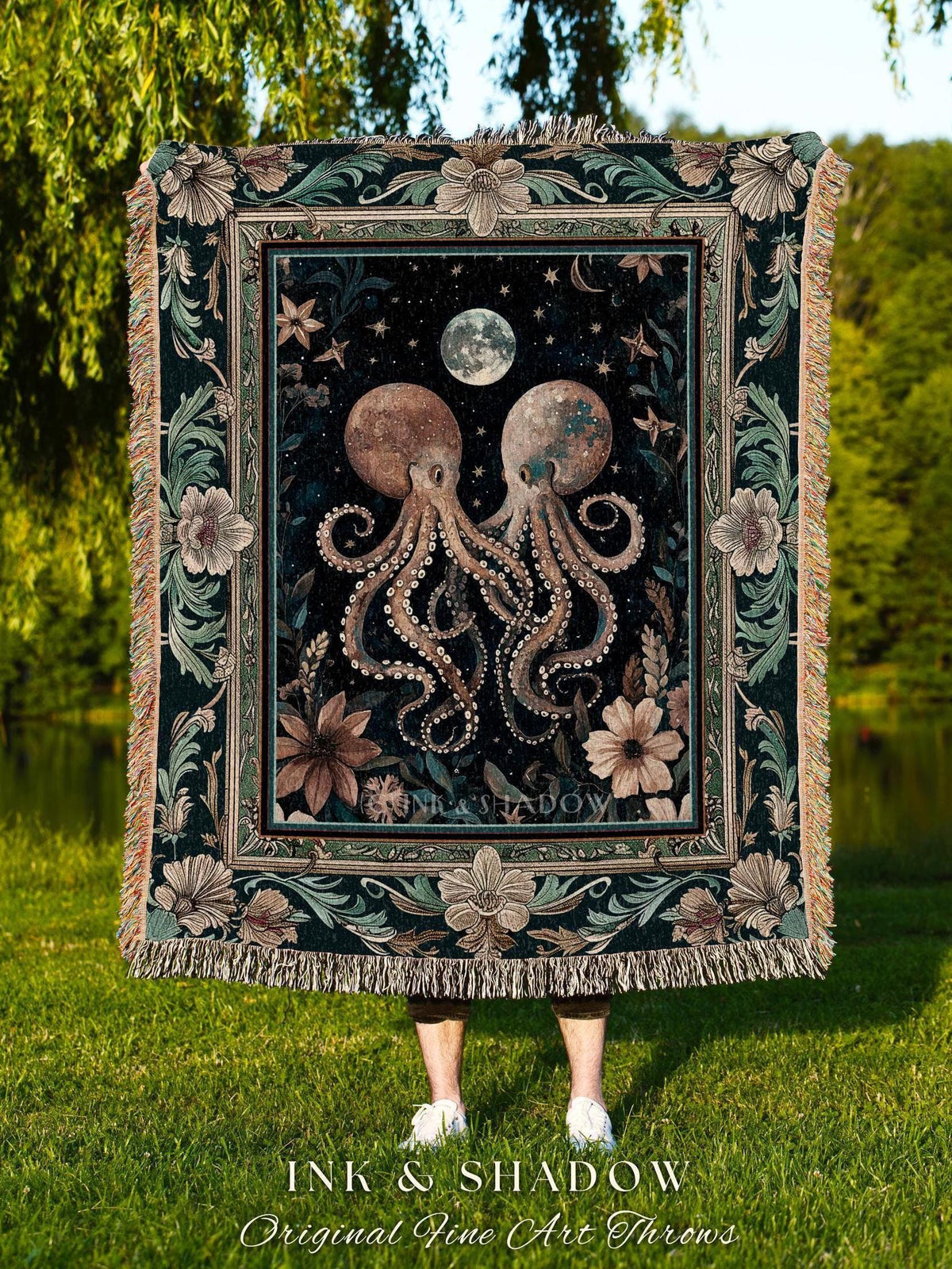 May include: A decorative throw blanket featuring a dark background with two octopuses, a moon, and stars. The blanket has a floral border and fringe. The text "INK & SHADOW Original Fine Art Throws" is at the bottom.