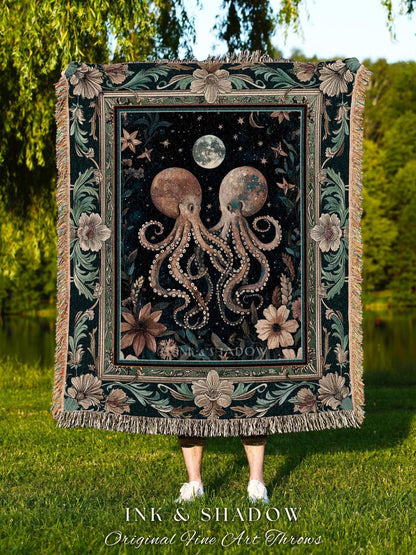 May include: A decorative throw blanket featuring a dark background with two octopuses, a moon, and stars. The blanket has a floral border and fringe. The text "INK & SHADOW Original Fine Art Throws" is at the bottom.