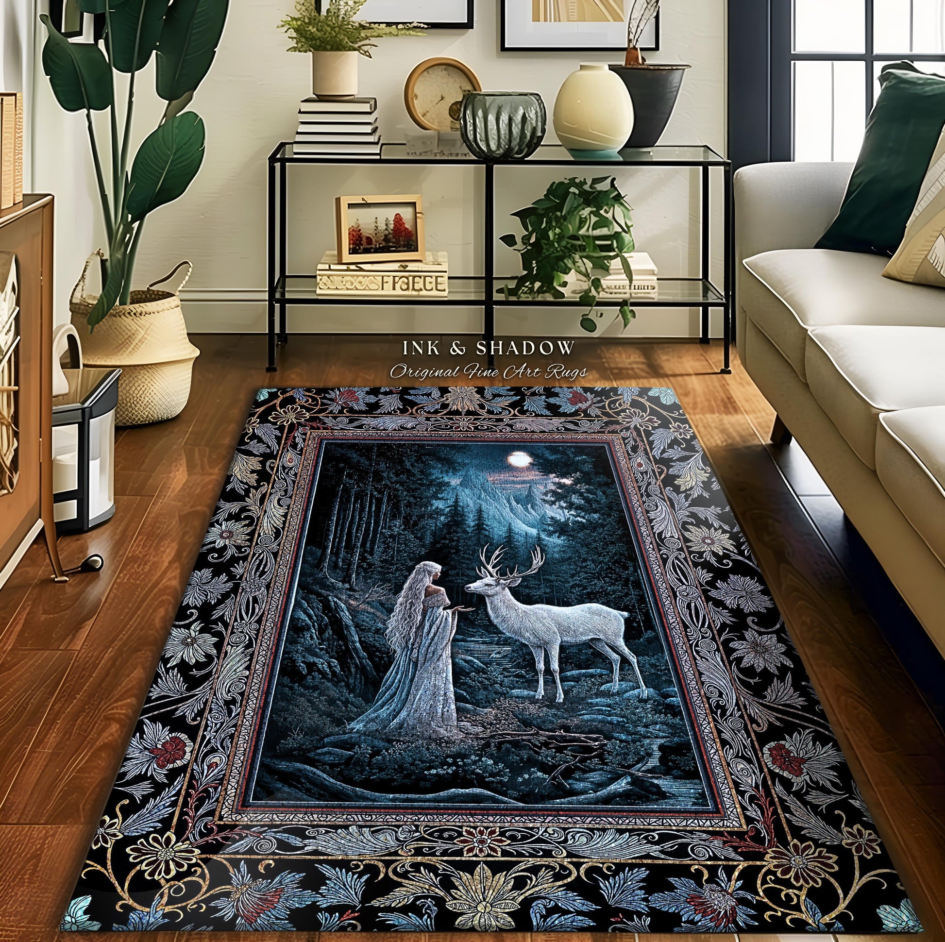 May include: A black and blue area rug with a detailed floral border. The center of the rug features a scene of a woman in a white dress standing in a forest with a white deer. The text "Ink & Shadow Original Fine Art Rugs" is printed on the rug.