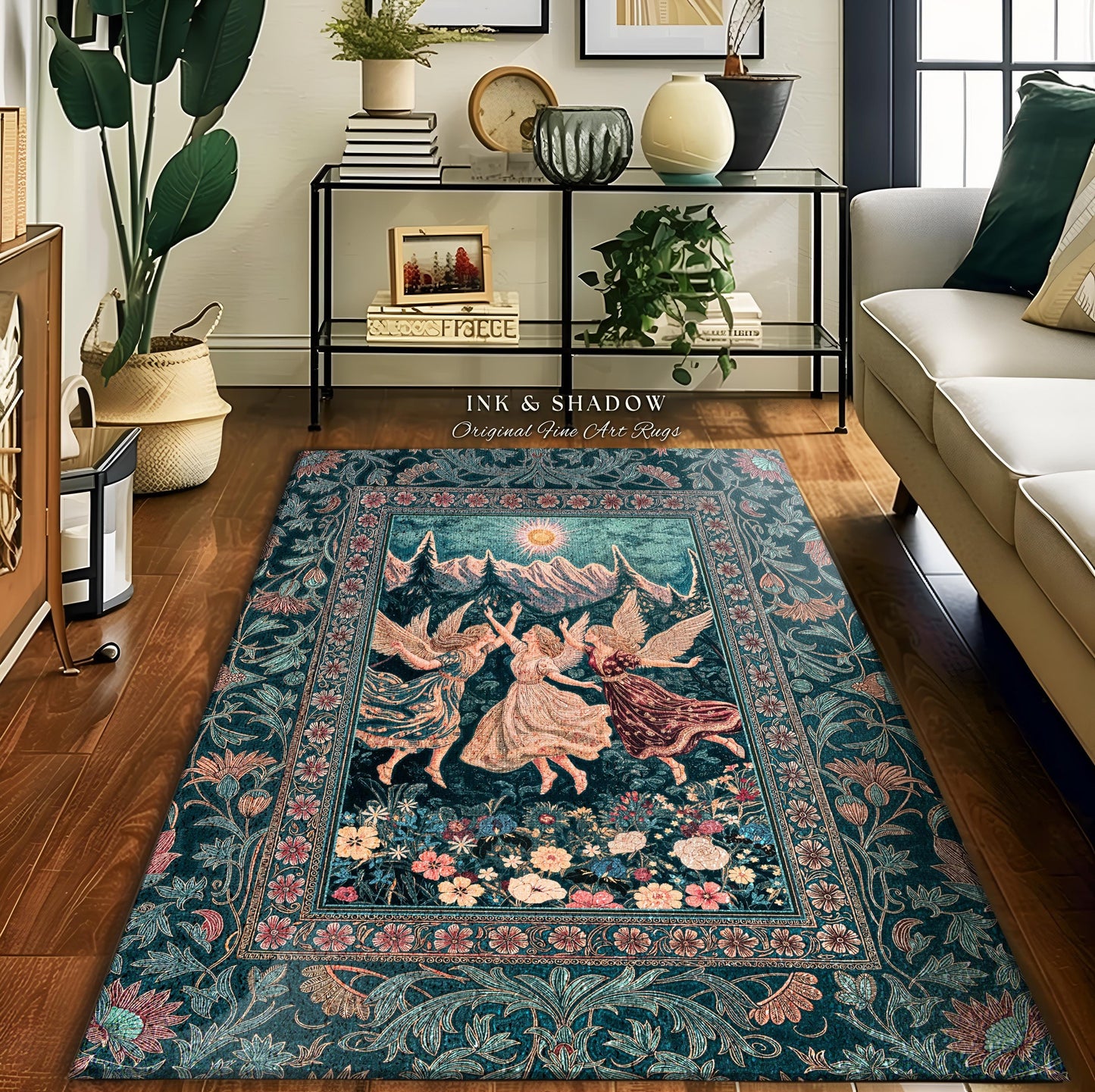 May include: A rectangular area rug with a teal background and a floral border. The center features a scene of three figures dancing in a meadow with mountains and a sun in the background. The text "INK & SHADOW Original Fine Art Rugs" is visible.