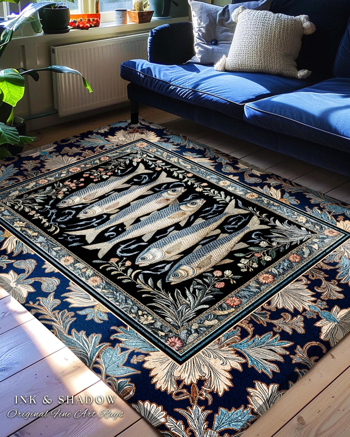 May include: A rectangular area rug with a black center featuring five fish illustrations. The rug has a dark blue floral border and the text "INK & SHADOW Original Fine Art Rugs". The rug is placed on a wooden floor near a blue sofa.