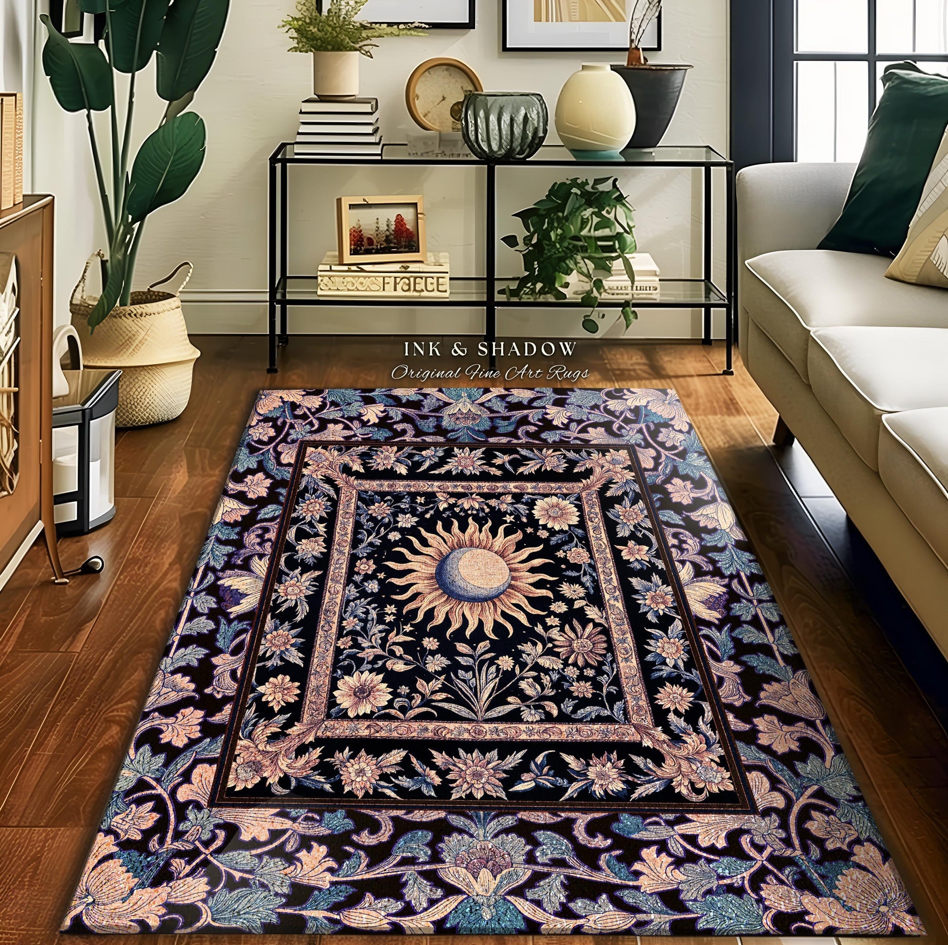 May include: A black and gold rug with a floral design and a sun and moon motif. The rug has a border of pink and blue flowers. The text "Ink & Shadow Original Fine Art Rugs" is printed on the rug.