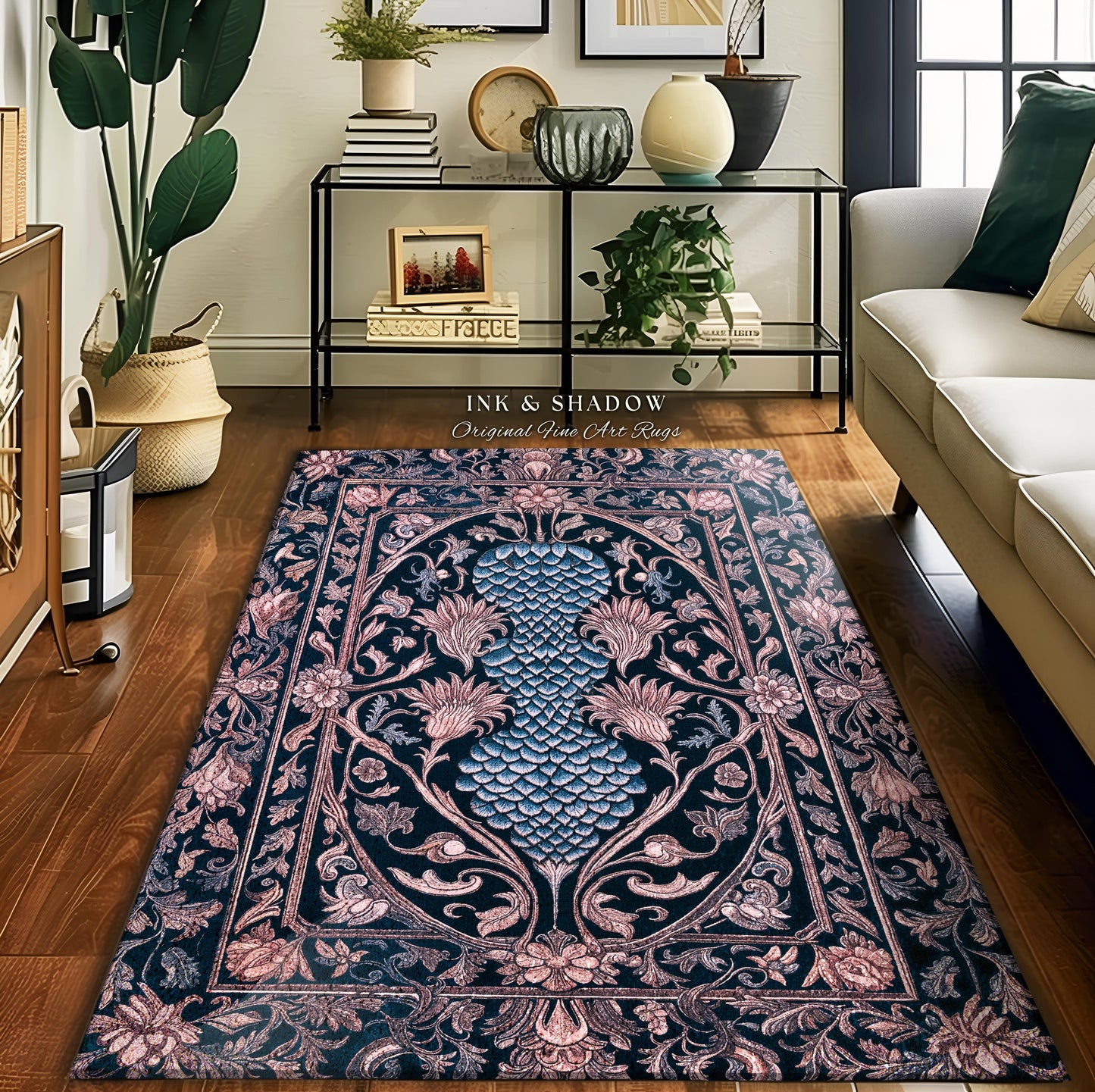 May include: A black and pink rug with a floral design. The rug has a blue and green floral pattern in the center and a pink and black floral border. The rug is on a wooden floor in a living room. The text 'INK & SHADOW Original Fine Art Rugs' is visible in the image.