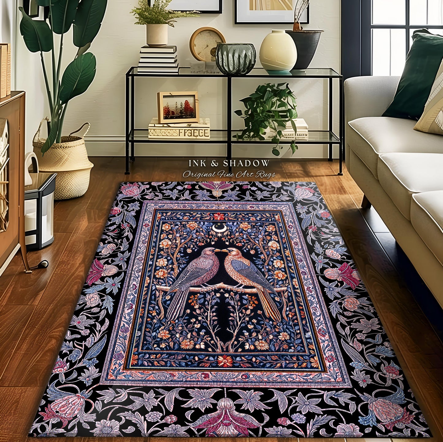 May include: A rectangular area rug with a black background and a central design featuring two birds perched on a branch. The birds are facing each other, with a crescent moon above them. The rug has a floral border in shades of blue, pink, and purple. The text 'INK & SHADOW Original Fine Art Rugs' is visible.