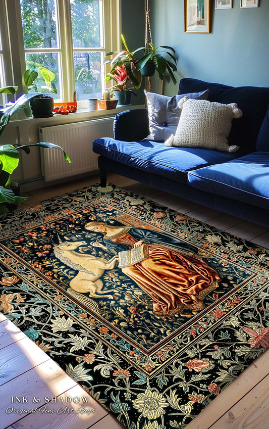 May include: A rectangular area rug with a detailed tapestry design featuring a unicorn, a woman, and floral patterns in shades of blue, brown, and gold. The rug is placed on a wooden floor, with a blue sofa in the background. The text "INK & SHADOW Original Fine Art Rugs" is visible.