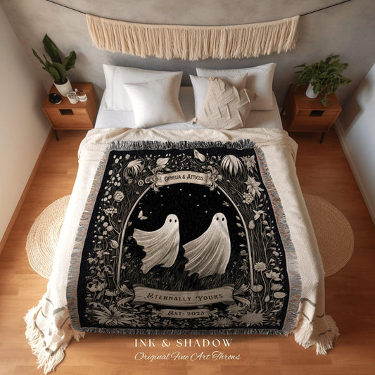 May include: A black and white throw blanket featuring two ghost figures within a floral archway. The blanket has the text "Ophelia & Atticus", "Eternally Yours", and "Est: 2023". The bottom of the blanket reads "INK & SHADOW Original Fine Art Throws".