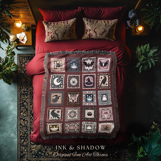 May include: A burgundy throw blanket with a repeating pattern of spooky images, including bats, spiders, and moons, is displayed on a red bed. The blanket has a fringed edge and is surrounded by red pillows and bedding. The text "INK & SHADOW Original Fine Art Throws" is at the bottom.
