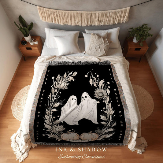 May include: A black throw blanket with a white floral design and two ghost figures. The words "Till Death Do Us Part" are printed on the side. The blanket also has the text "INK & SHADOW Enchanting Curationss".