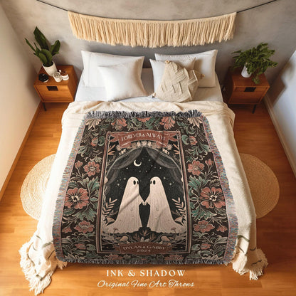 May include: A decorative throw blanket with a floral and ghost design. The blanket features the text "Forever & Always" and "Dylan & Gabby 2024". The blanket is black with pink and green floral accents. The bottom of the blanket has a fringe.