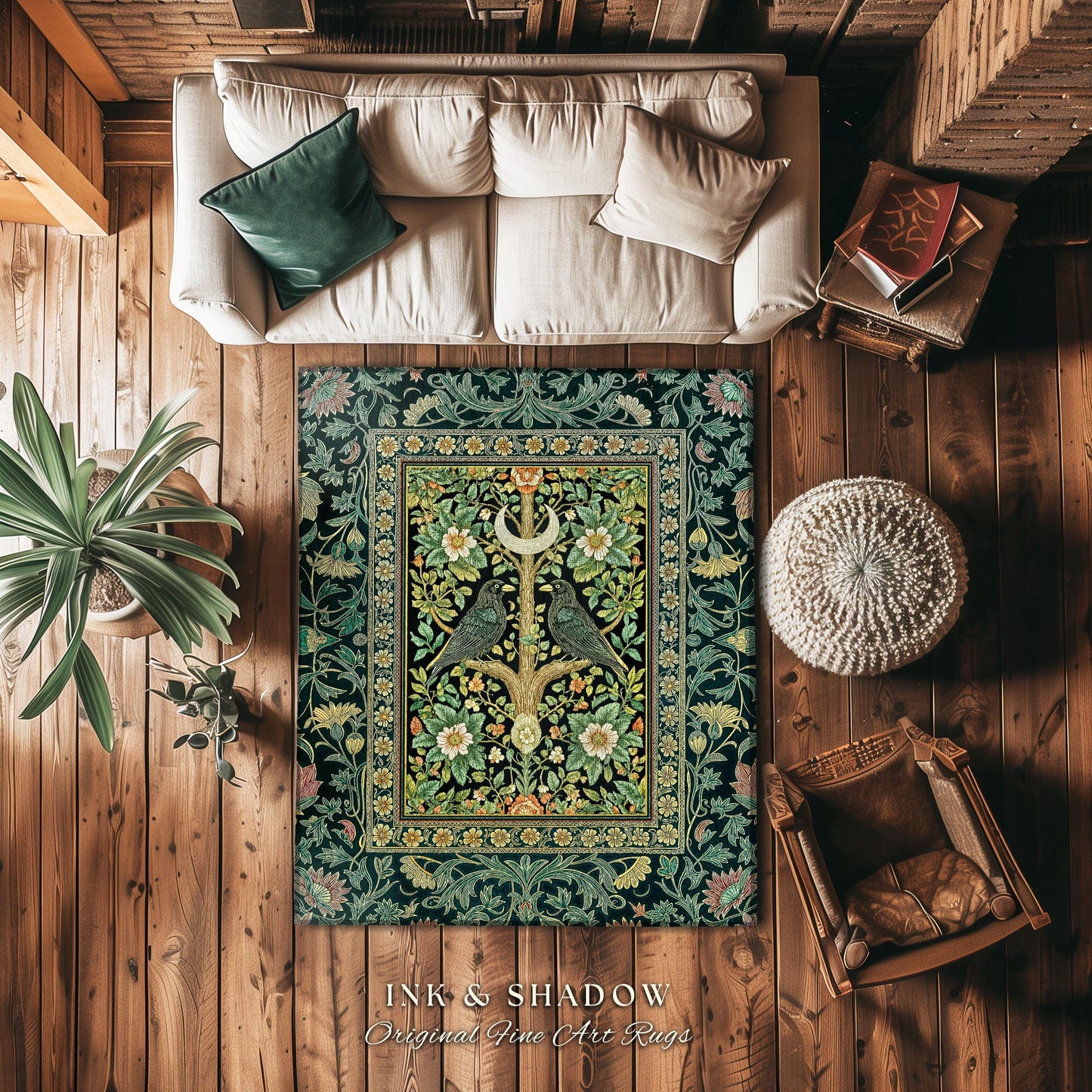 May include: A decorative rug with a black background and a central floral design. The rug features a detailed pattern with green, yellow, and white flowers, and two birds perched on a tree. The rug is placed on a wooden floor, alongside a white couch, a plant, and a chair.