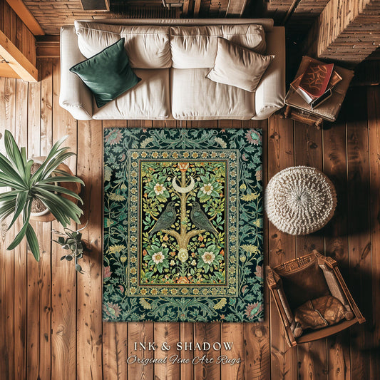 May include: A decorative rug with a black background and a central floral design. The rug features a detailed pattern with green, yellow, and white flowers, and two birds perched on a tree. The rug is placed on a wooden floor, alongside a white couch, a plant, and a chair.