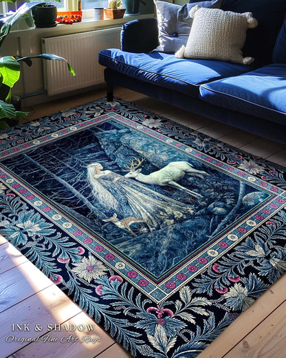 May include: A blue and white rug with a floral border and a scene of a woman and a deer in a forest. The rug is on a wooden floor in a living room with a blue sofa and plants.