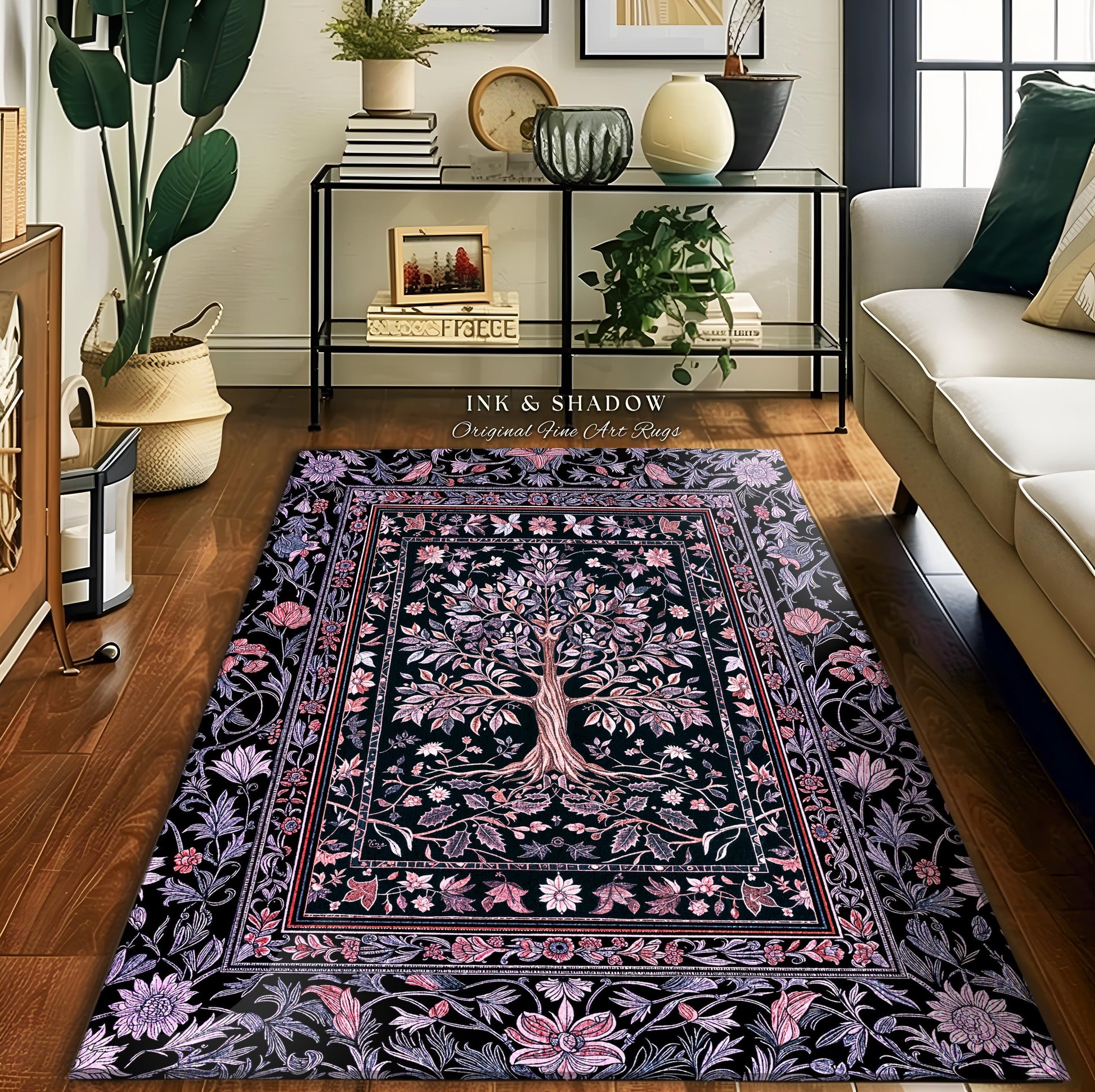 May include: A rectangular area rug with a black background and a central tree design. The tree is surrounded by floral and leaf patterns in shades of pink, purple, and white. The rug has a decorative border and the text "INK & SHADOW Original Fine Art Rugs".