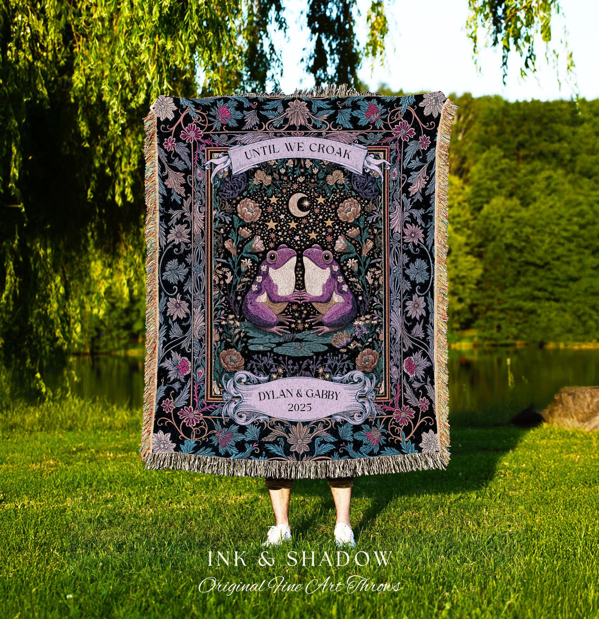 May include: A decorative throw blanket with a black background and a central design featuring two purple frogs, a crescent moon, and stars. The text "UNTIL WE CROAK" is at the top, and "DYLAN & GABBY 2025" is at the bottom. The blanket has a fringed edge.
