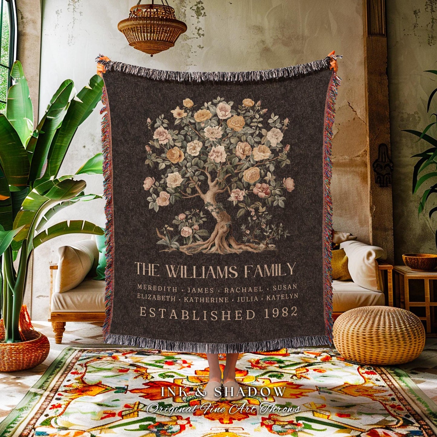 May include: Dark gray throw blanket featuring a floral tree design with the text "THE WILLIAMS FAMILY" and names. The blanket has a fringed edge and is labeled "ESTABLISHED 1982".