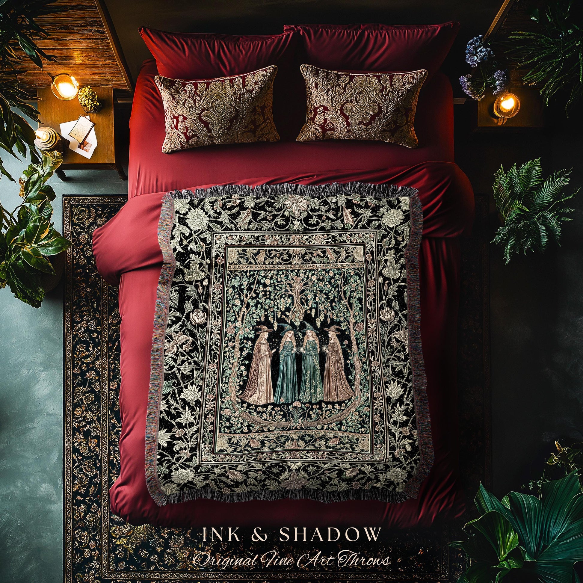 May include: A bed with red bedding, two patterned pillows, and a decorative throw blanket. The throw features a detailed illustration of figures in a forest. The text "INK & SHADOW Original Fine Art Throws" is visible at the bottom.