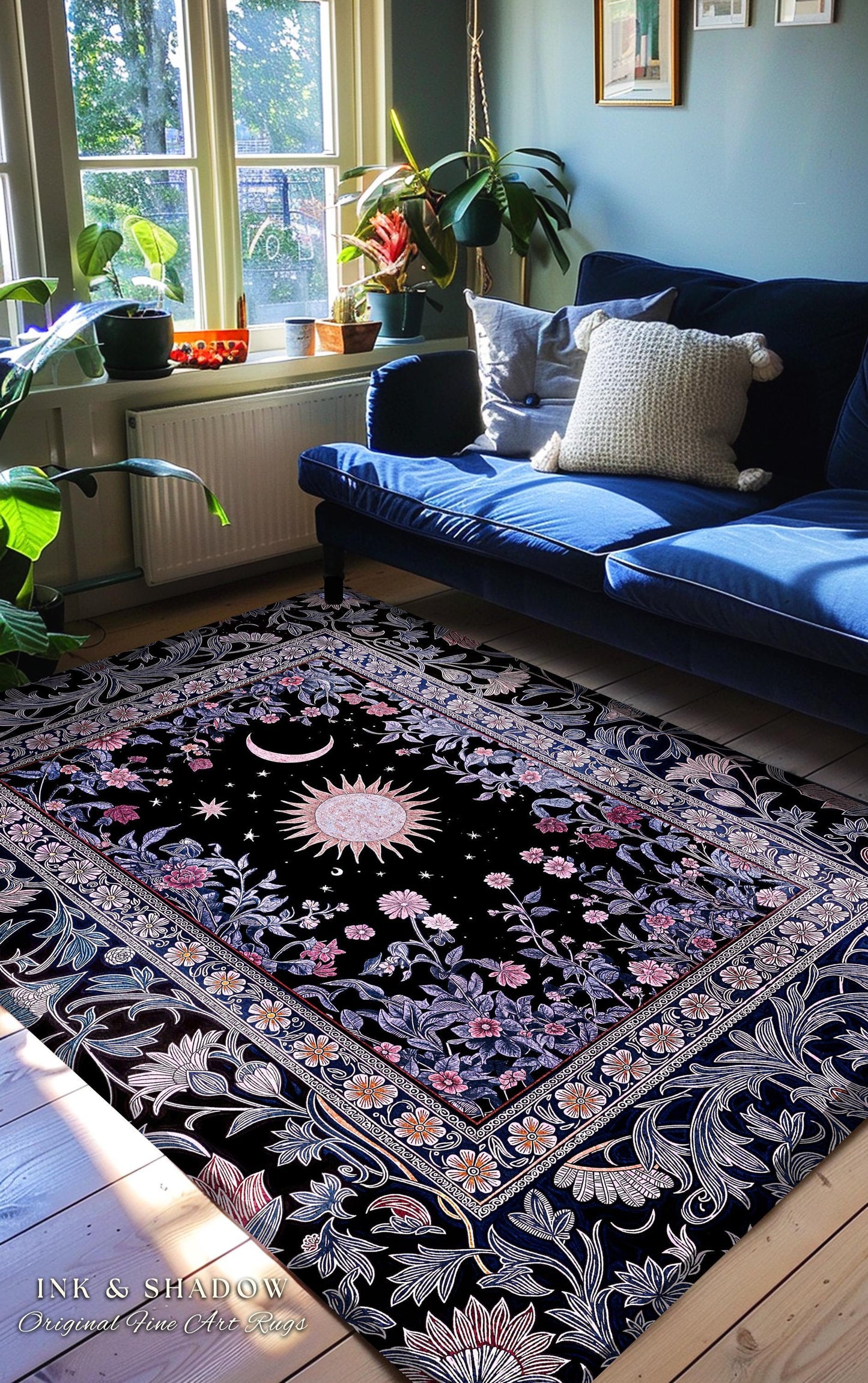 May include: Black area rug with a celestial design featuring a sun, moon, and stars. The rug has a floral border with pink and white flowers. The text "INK & SHADOW Original Fine Art Rugs" is visible in the bottom left corner.