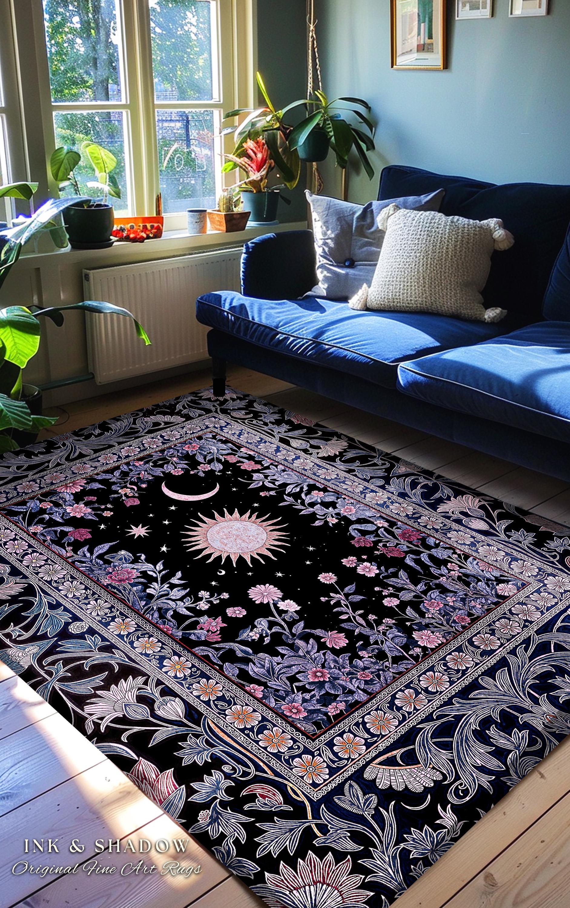 May include: Black area rug with a celestial design featuring a sun, moon, and stars. The rug has a floral border with pink and white flowers. The text "INK & SHADOW Original Fine Art Rugs" is visible in the bottom left corner.