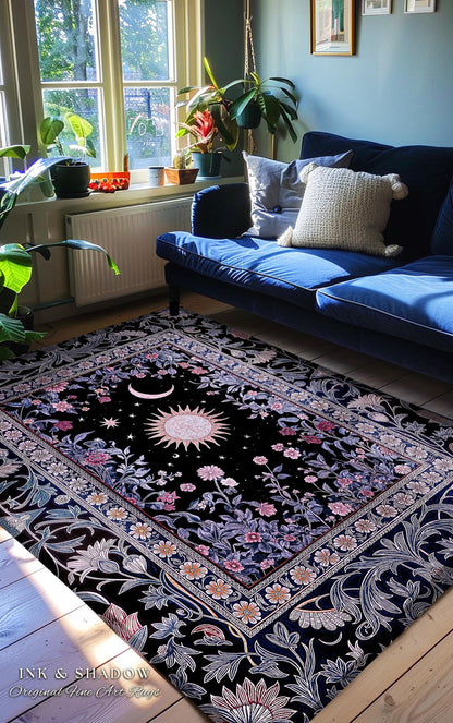 May include: Black area rug with a celestial design featuring a sun, moon, and stars. The rug has a floral border with pink and white flowers. The text "INK & SHADOW Original Fine Art Rugs" is visible in the bottom left corner.