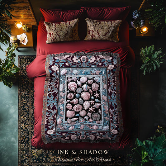May include: A decorative throw blanket with a seashell design, featuring various shells and starfish in shades of pink, blue, and black. The blanket is displayed on a red bed with matching pillows. The text "INK & SHADOW Original Fine Art Throws" is visible.