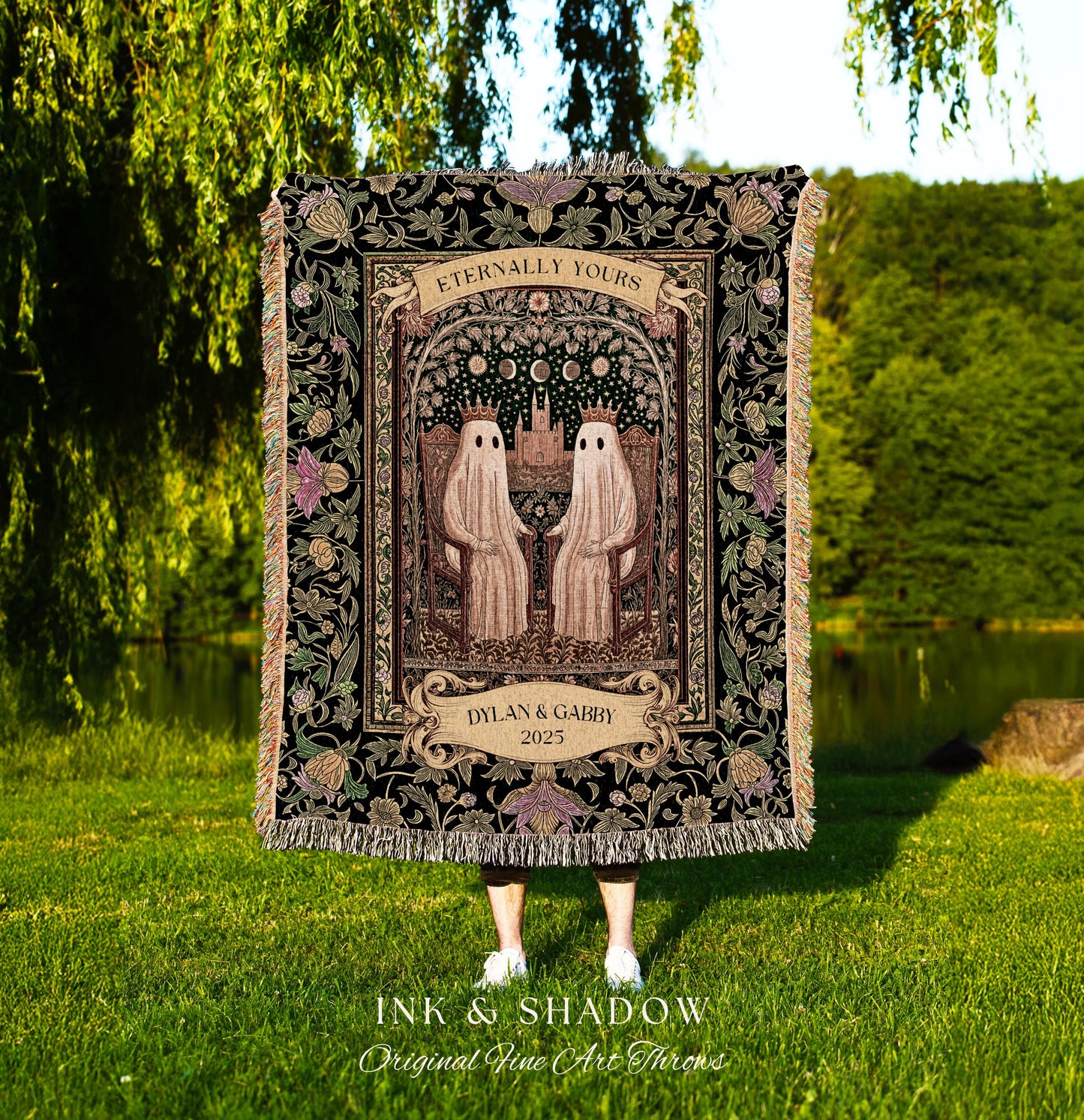 May include: A black throw blanket with a decorative floral border and fringe. The center features two ghost figures holding hands under an arch with the words "Eternally Yours". Below is a banner with the names "Dylan & Gabby" and the year "2025".