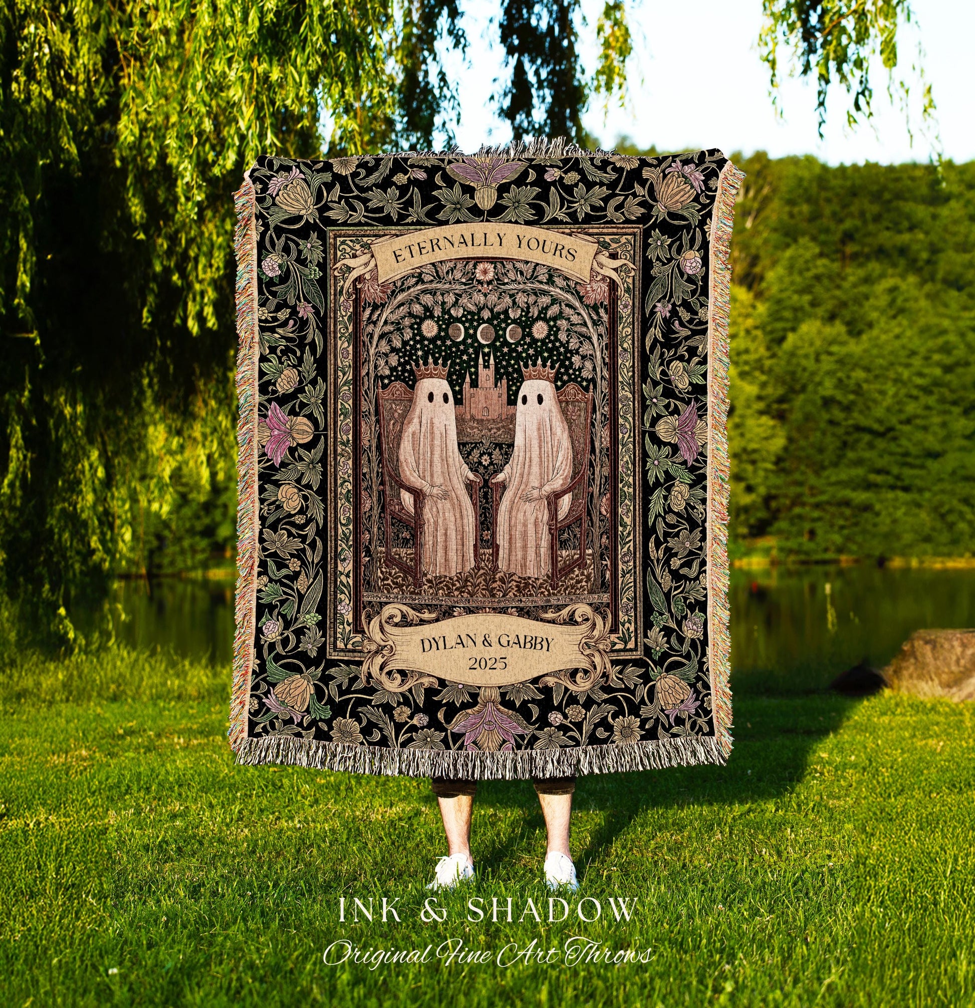 May include: A black throw blanket with a decorative floral border and fringe. The center features two ghost figures holding hands under an arch with the words "Eternally Yours". Below is a banner with the names "Dylan & Gabby" and the year "2025".