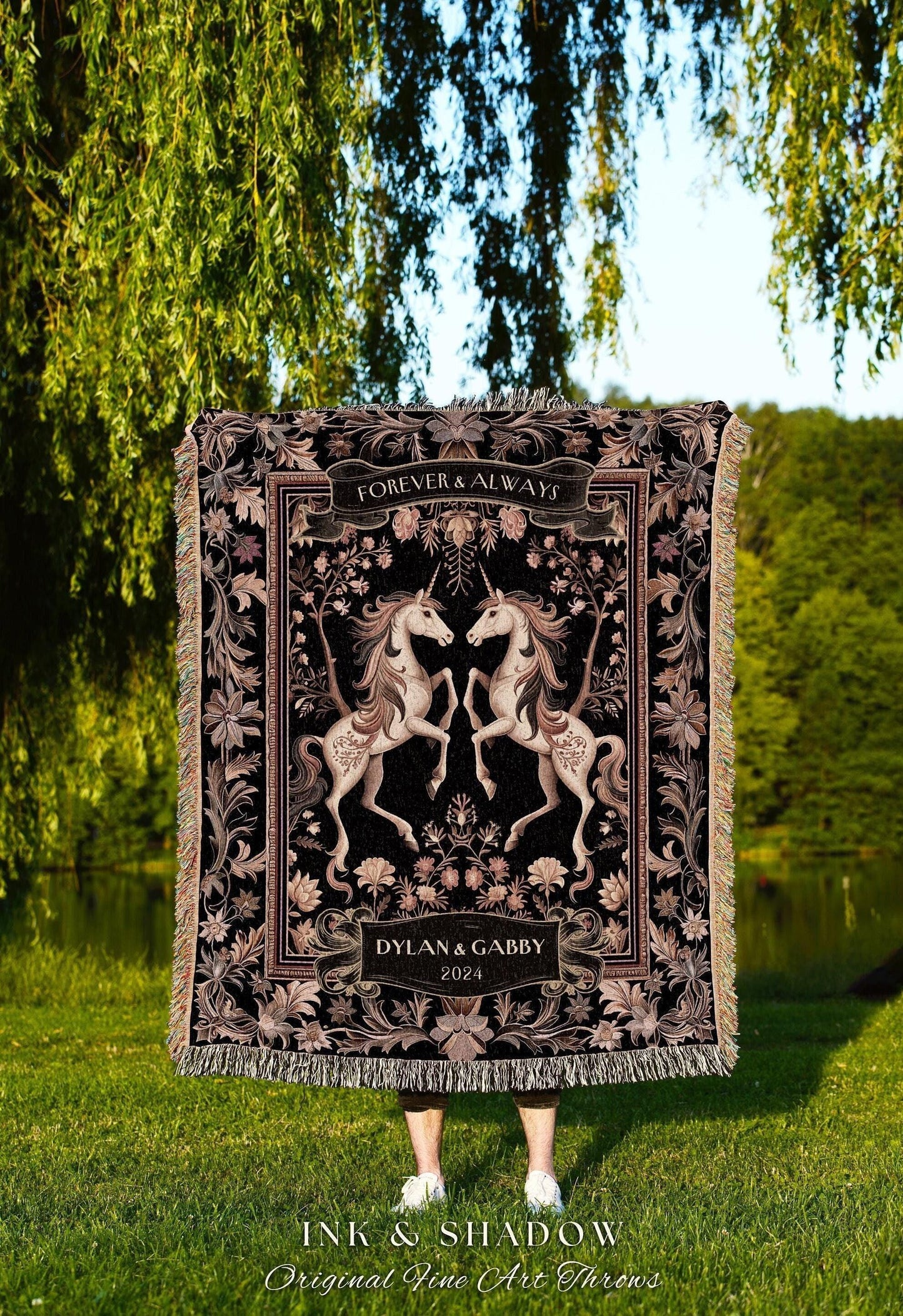 May include: Black and tan woven throw blanket featuring two unicorns facing each other. The blanket has a floral and scroll design with the words "Forever & Always" and the names "Dylan & Gabby" with the year "2024". The blanket is fringed.