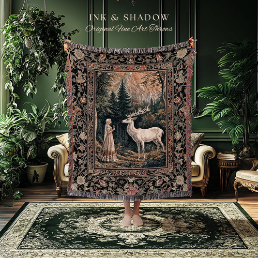 May include: A tapestry throw blanket with a forest scene featuring a woman and a white deer. The throw has a black border with floral and leaf patterns, and the text "INK & SHADOW Original Fine Art Throws" is at the top.