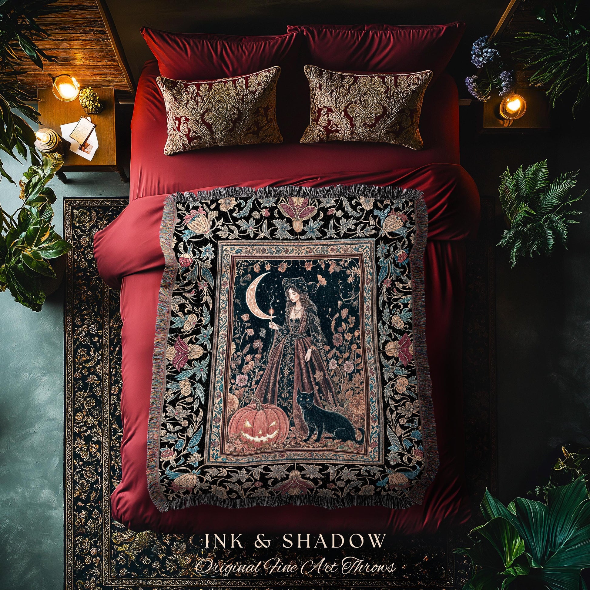 May include: A decorative throw blanket with a dark background featuring a woman, a crescent moon, and a jack-o'-lantern. The blanket is fringed and has floral and botanical patterns. The text "INK & SHADOW Original Fine Art Throws" is at the bottom.