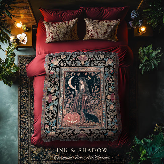 May include: A decorative throw blanket with a dark background featuring a woman, a crescent moon, and a jack-o'-lantern. The blanket is fringed and has floral and botanical patterns. The text "INK & SHADOW Original Fine Art Throws" is at the bottom.