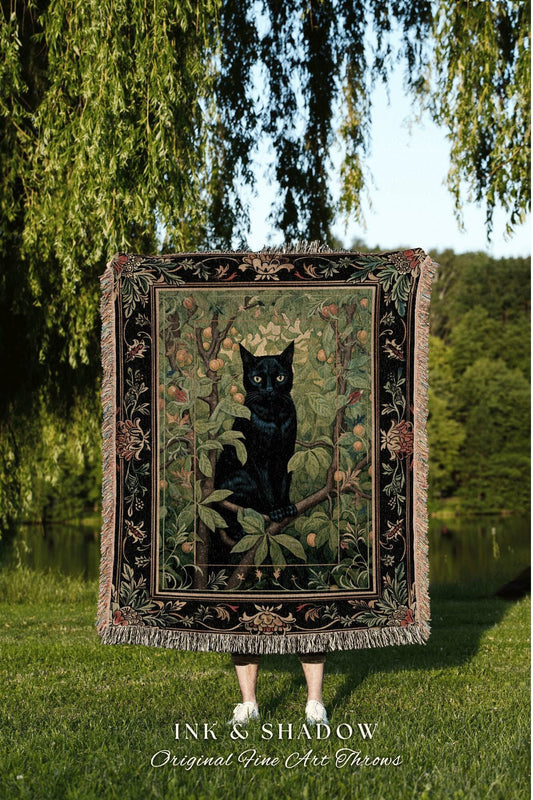 May include: A tapestry throw blanket featuring a black cat perched on a tree branch, surrounded by foliage and fruit. The blanket has a black border with floral designs and fringe. The text "INK & SHADOW Original Fine Art Throws" is at the bottom.