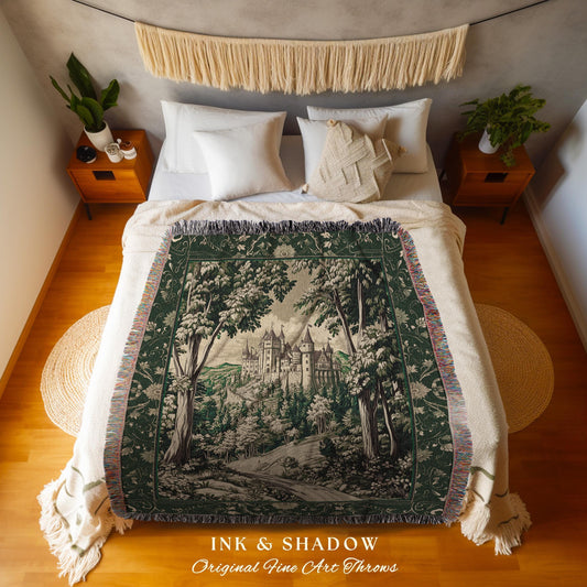 May include: A dark green and white throw blanket with a forest and castle scene. The blanket is draped over a bed with white bedding. The text "INK & SHADOW Original Fine Art Throws" is at the bottom.