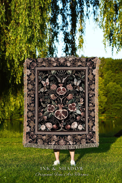 May include: A black throw blanket with a pomegranate and floral design. The blanket has a decorative border and fringe. The text "INK & SHADOW Original Fine Art Throws" is at the bottom of the image.