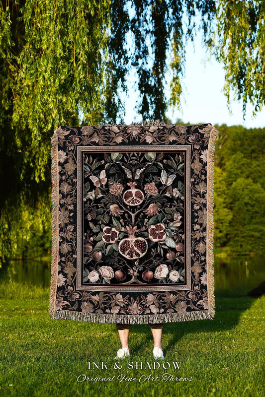 May include: A black throw blanket with a pomegranate and floral design. The blanket has a decorative border and fringe. The text "INK & SHADOW Original Fine Art Throws" is at the bottom of the image.