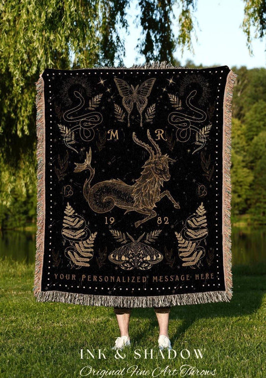 May include: Black throw blanket with a gold Capricorn design, butterfly, and snake illustrations. Features the text "YOUR PERSONALIZED MESSAGE HERE" and the brand "INK & SHADOW Original Fine Art Throws". The blanket has a fringed edge.