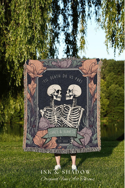 May include: A dark blanket featuring a design with two skeletons embracing, with the text "'TIL DEATH DO US PART". The blanket includes floral accents and the names "JANET & KENNETH" with "EST. 2022".