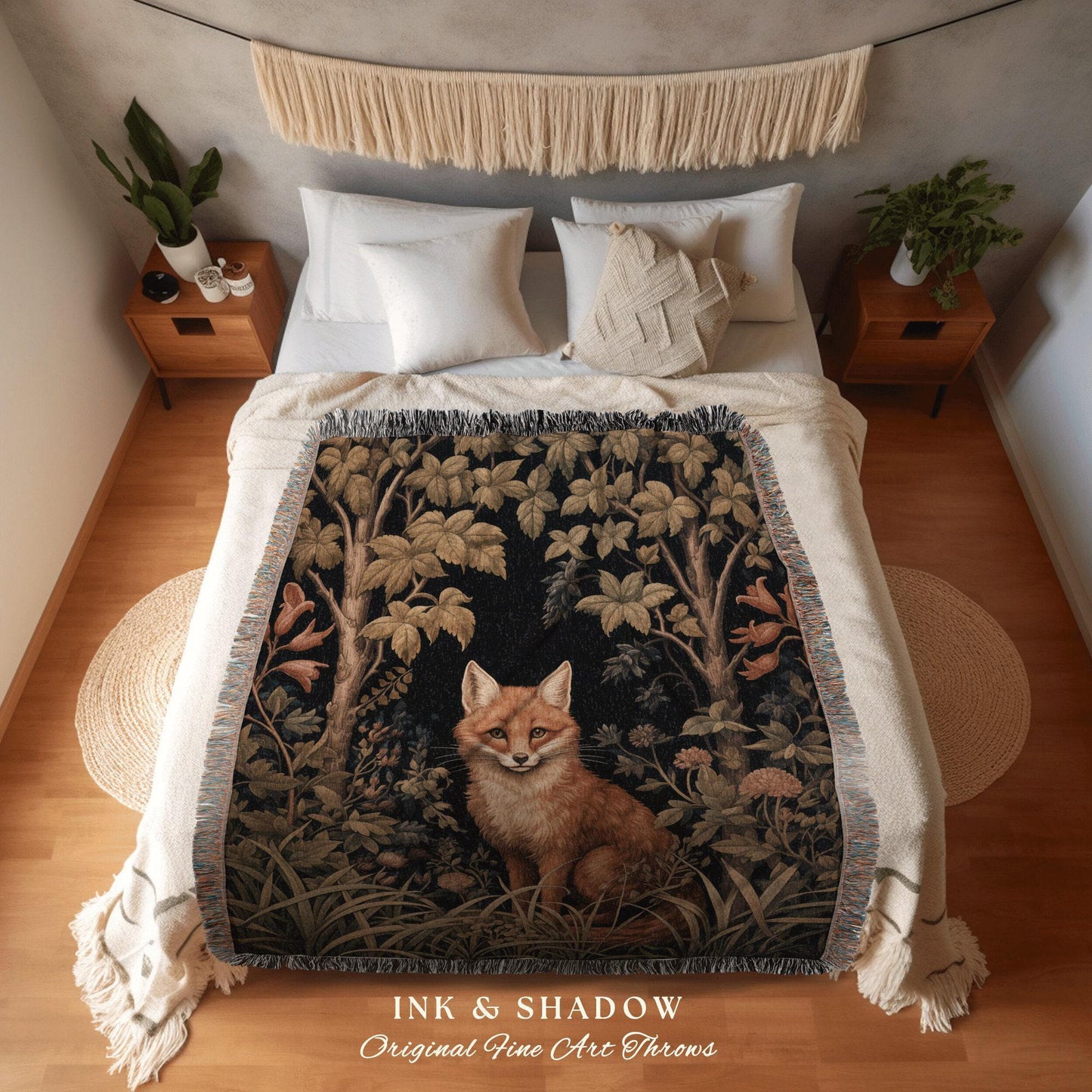 May include: A decorative throw blanket featuring a forest scene with a fox. The blanket has a black background with trees, foliage, and a sitting fox in shades of brown, green, and tan. The text "INK & SHADOW Original Fine Art Throws" is at the bottom.