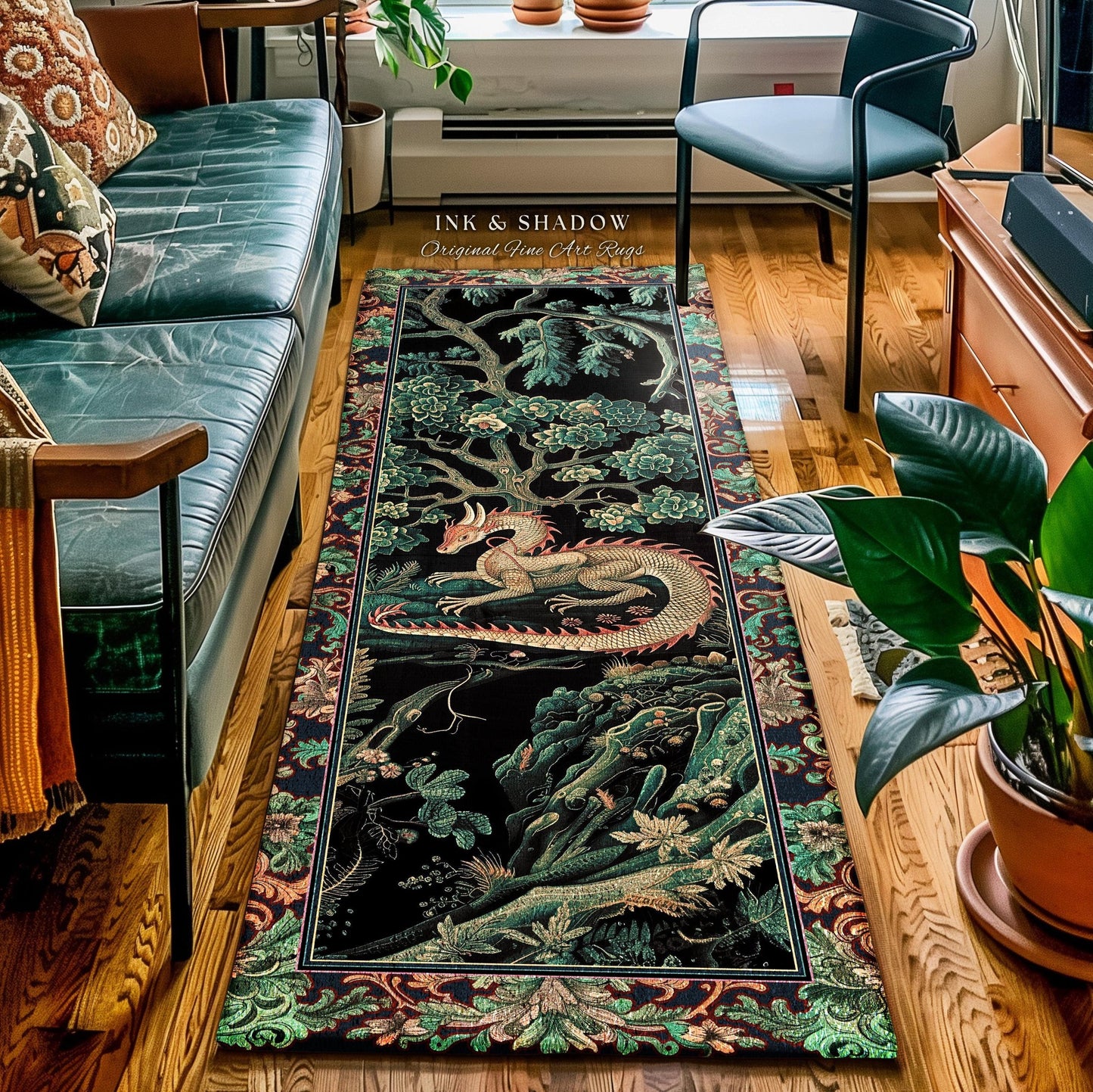 May include: A rectangular black rug with a detailed illustration of a dragon, trees, and foliage in shades of green, red, and gold. The rug has a decorative border and the text "INK & SHADOW Original Fine Art Rugs".
