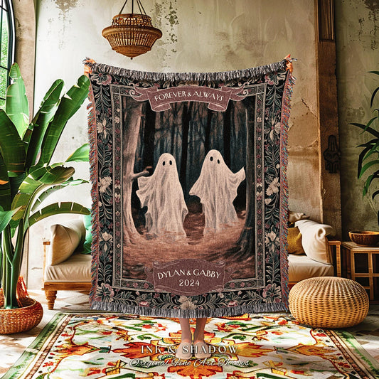 May include: A woven tapestry blanket featuring two ghost figures in a forest scene. The blanket has a dark border with floral patterns and the text "FOREVER & ALWAYS" and "DYLAN & GABBY 2024". The blanket has a fringed edge.