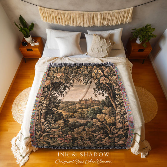 May include: A woven throw blanket with a landscape scene featuring trees, a castle, and a forest. The blanket has a fringe border and is draped over a bed. The text "INK & SHADOW Original Fine Art Throws" is at the bottom.