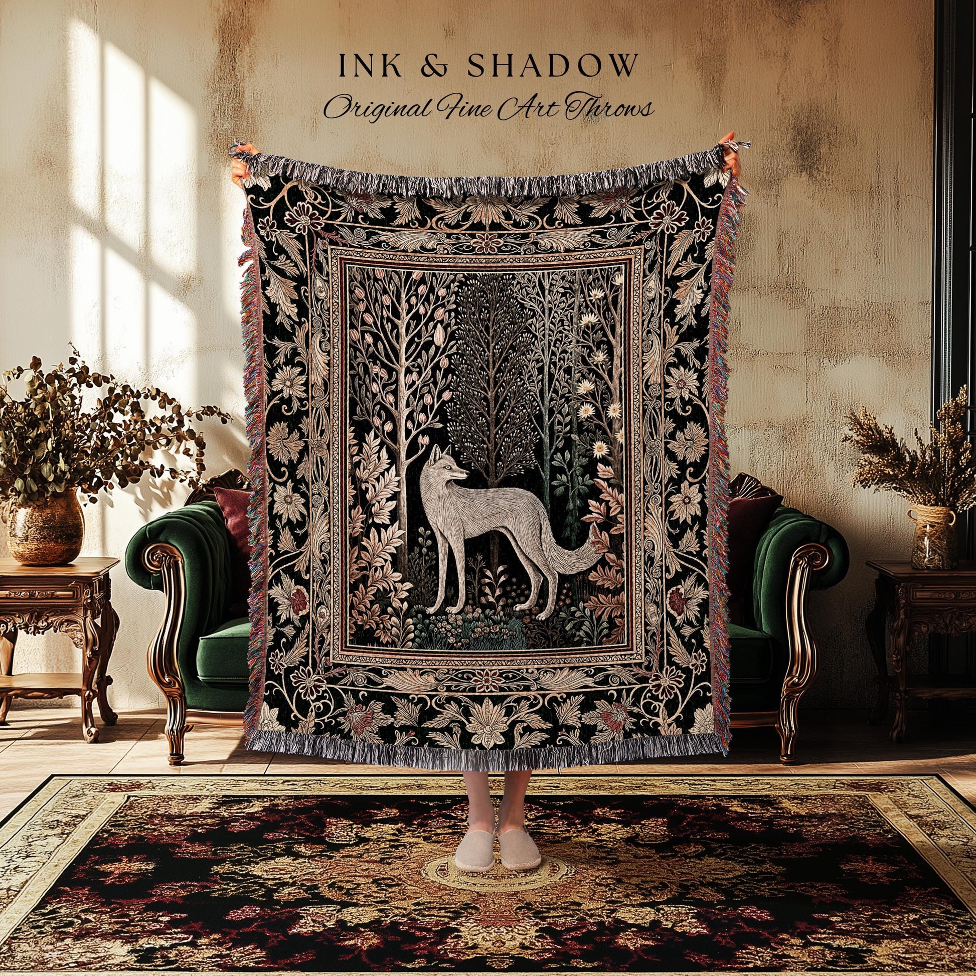 May include: A black throw blanket with a detailed forest and fox design. The blanket has a fringed edge and the text "INK & SHADOW Original Fine Art Throws" at the top. The blanket is displayed in a room with a green sofa and a patterned rug.