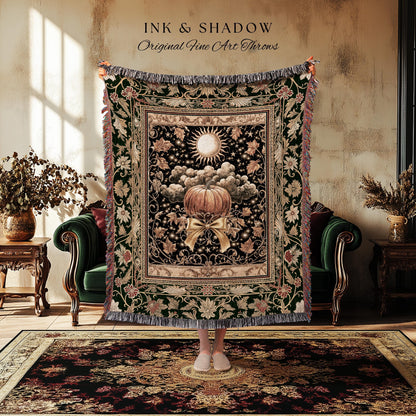 May include: A decorative throw blanket with a pumpkin design. The blanket features a black background with a pumpkin, sun, and cloud design. The blanket has a green border with floral and leaf patterns and a fringed edge. The text "INK & SHADOW Original Fine Art Throws" is at the top.