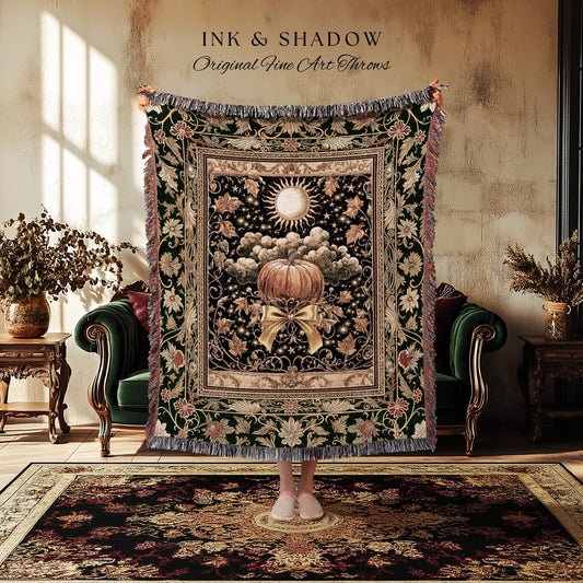 May include: A decorative throw blanket with a pumpkin design. The blanket features a black background with a pumpkin, sun, and cloud design. The blanket has a green border with floral and leaf patterns and a fringed edge. The text "INK & SHADOW Original Fine Art Throws" is at the top.