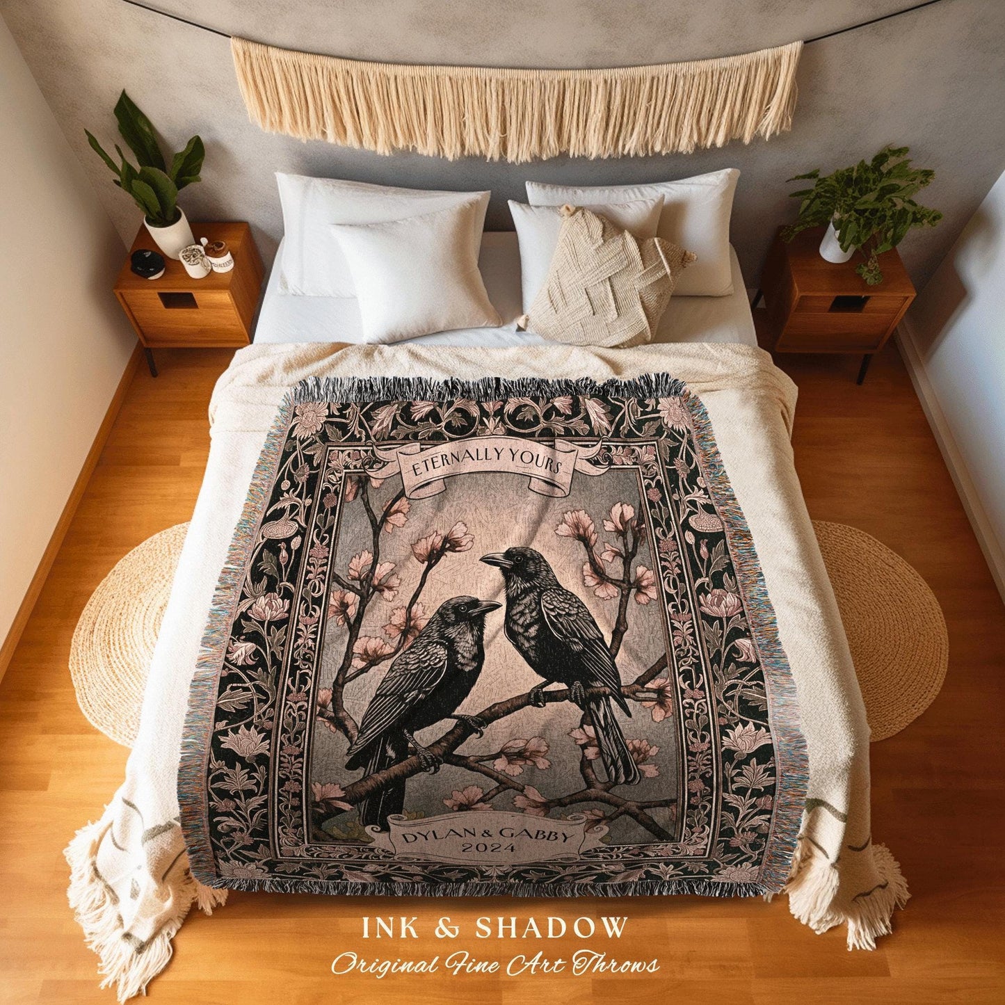 May include: A woven throw blanket featuring two black birds perched on a flowering branch. The design includes the text "Eternally Yours" and "Dylan & Gabby 2024". The blanket has a fringed edge and the words "INK & SHADOW Original Fine Art Throws".