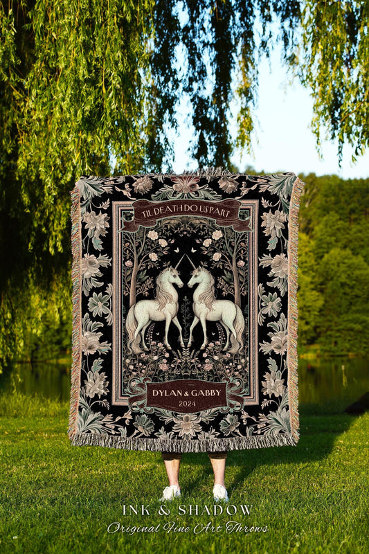 May include: Black throw blanket featuring two white unicorns facing each other, framed by floral and tree designs. The text "TIL DEATH DO US PART" is at the top, with "DYLAN & GABBY 2024" below. The blanket has a fringed edge.