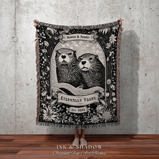 May include: Black and white throw blanket featuring an illustration of two otters within a floral frame. The blanket includes the text "HARPER & AUDREY", "ETERNALLY YOURS", and "EST: 2023". The bottom of the blanket reads "INK & SHADOW Original Fine Art Throws".