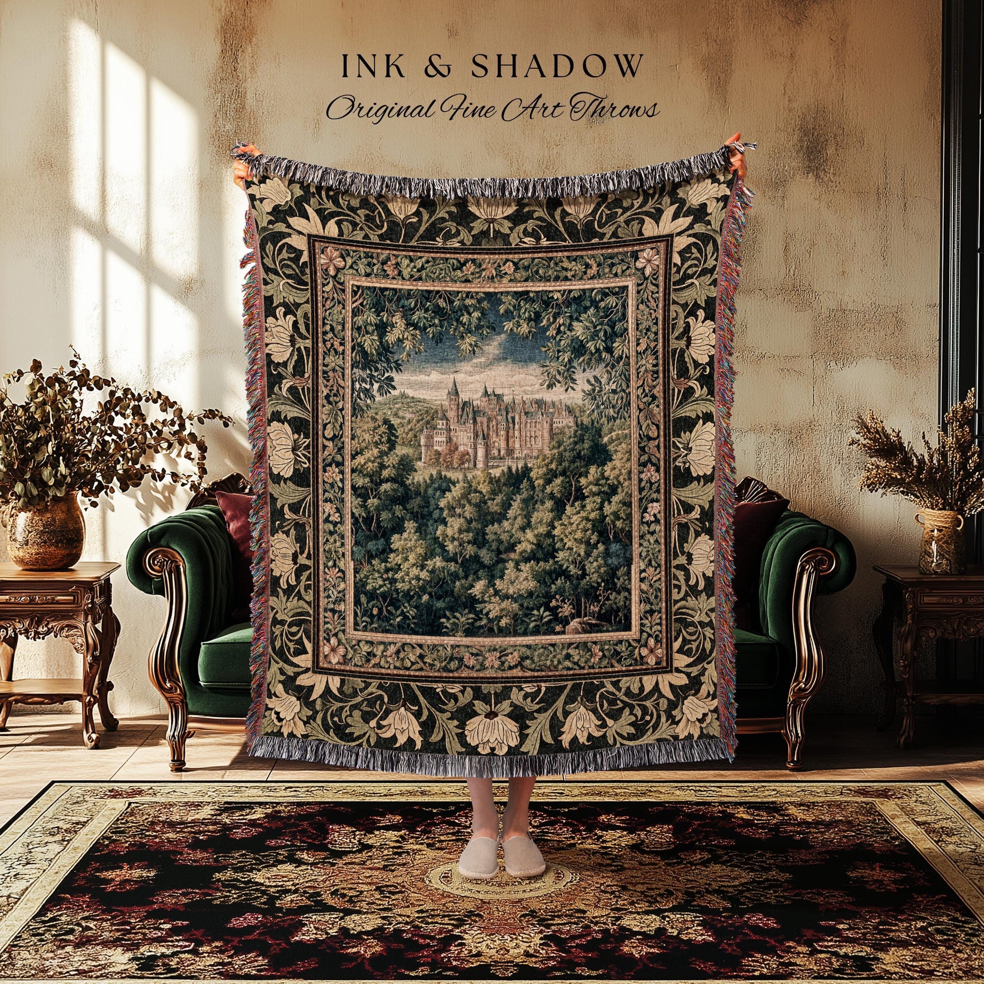 May include: A tapestry throw blanket with a castle scene framed by a floral border. The throw is dark green with cream and red accents, and the text "INK & SHADOW Original Fine Art Throws" is at the top.